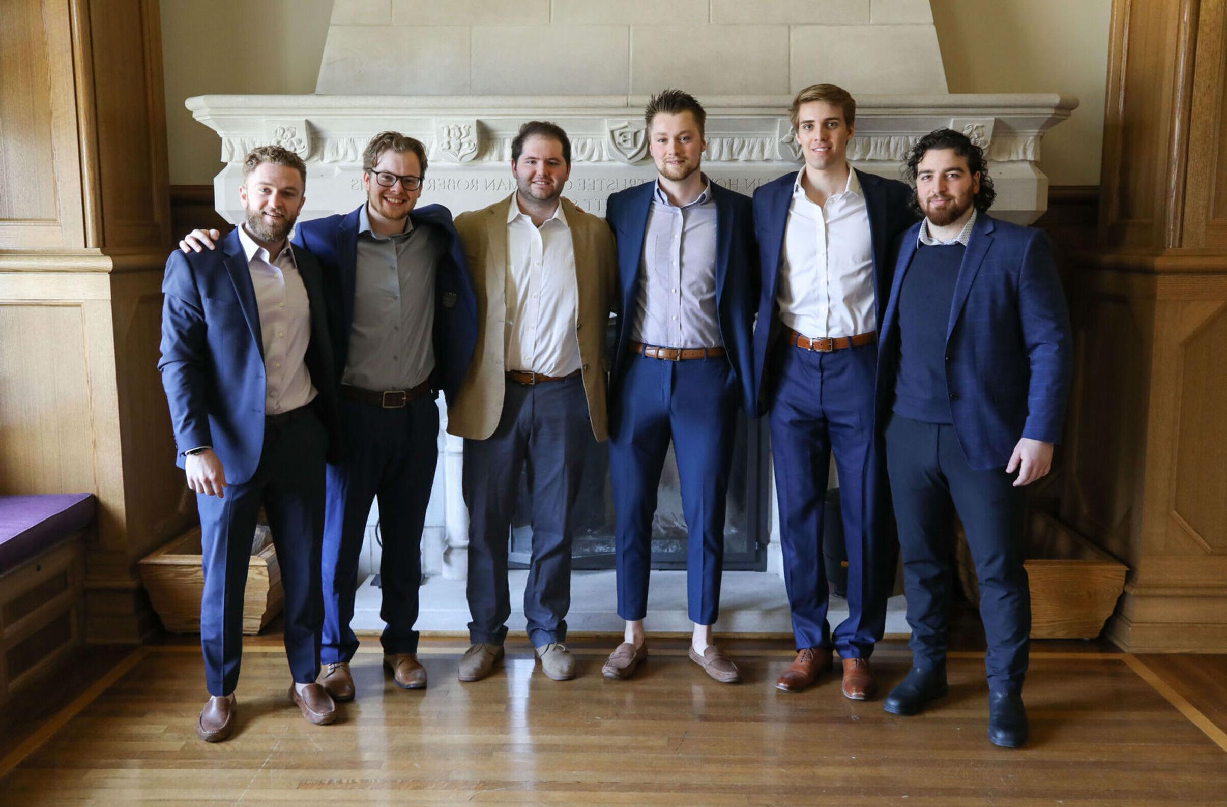 Male members of Sigma Beta Delta Business honor society stand together after the induction ceremony